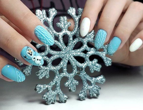 девушка с голубыми ногтями держит искусственную снежинку